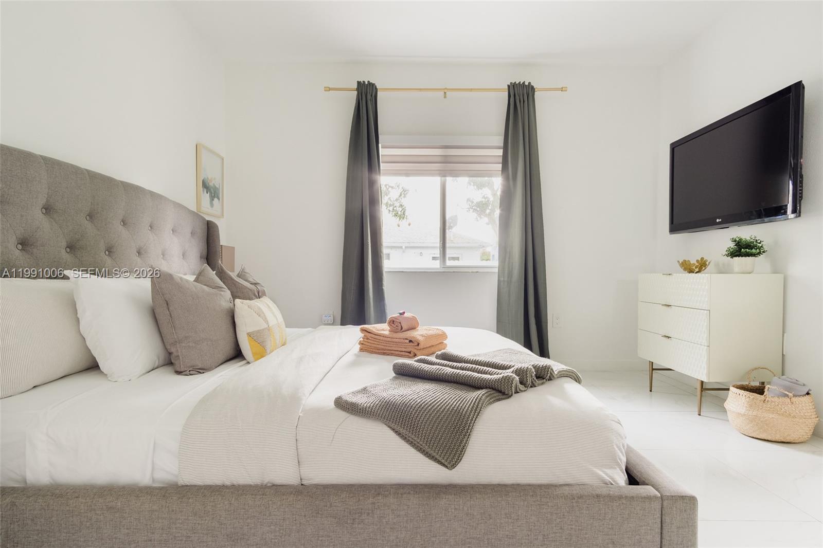 8765 Northwest 22nd Place Miami, FL 33147 - Photo 16 of 37 a bedroom with a bed and flat screen tv