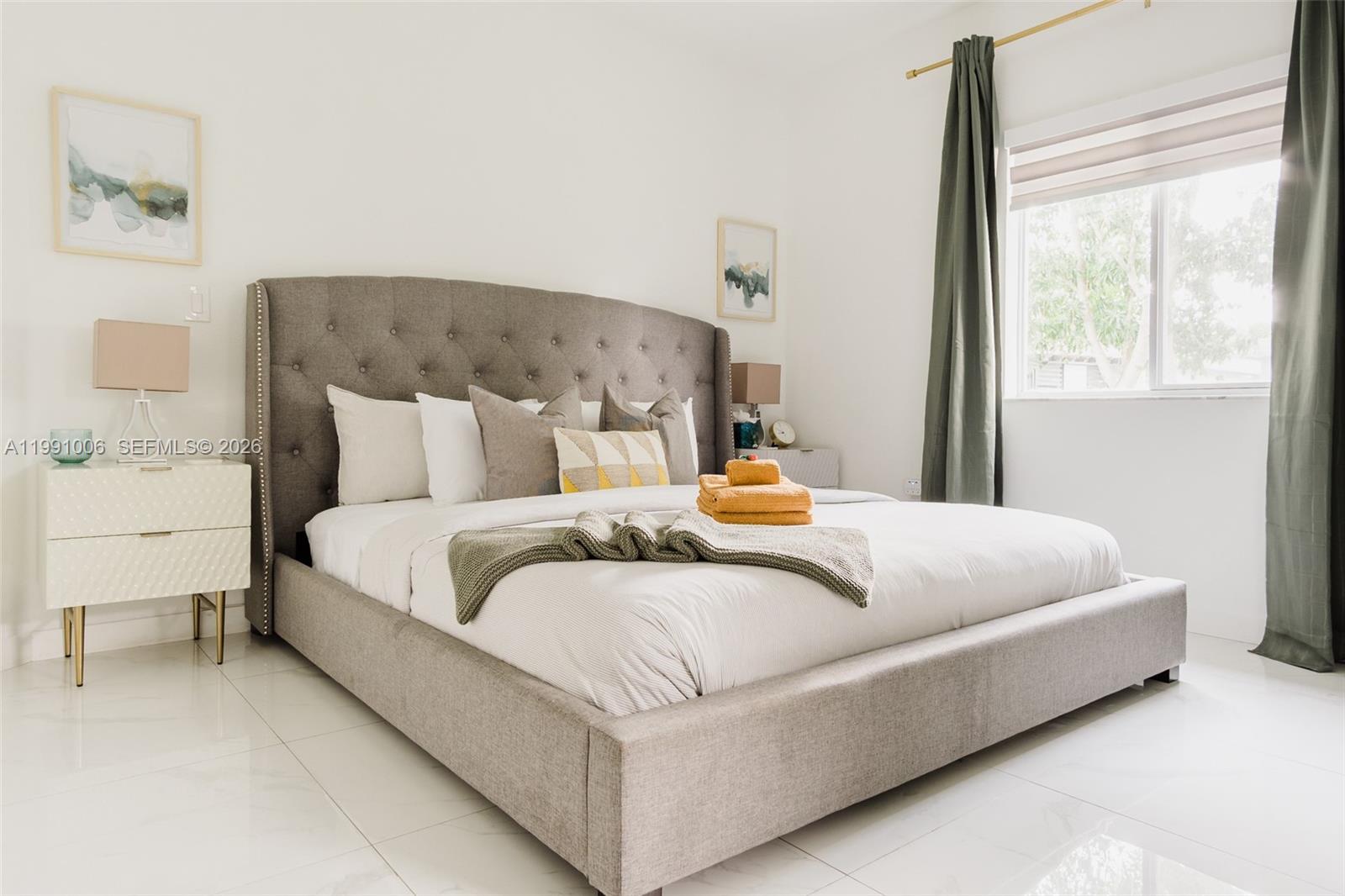 8765 Northwest 22nd Place Miami, FL 33147 - Photo 17 of 37 a bedroom with a bed and window