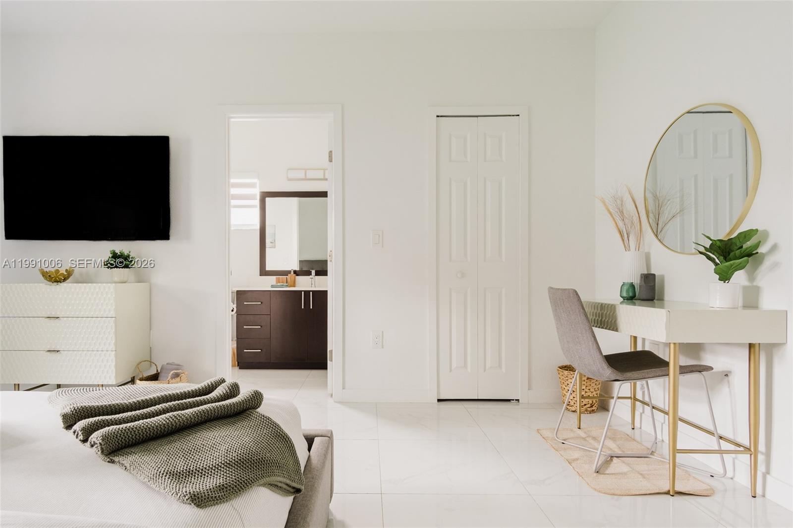 8765 Northwest 22nd Place Miami, FL 33147 - Photo 18 of 37 a bedroom with a bed and a flat screen tv