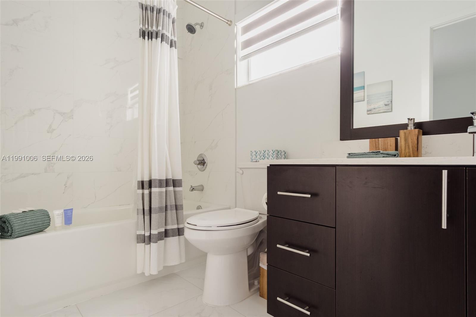 8765 Northwest 22nd Place Miami, FL 33147 - Photo 26 of 37 a bathroom with a sink a toilet and shower