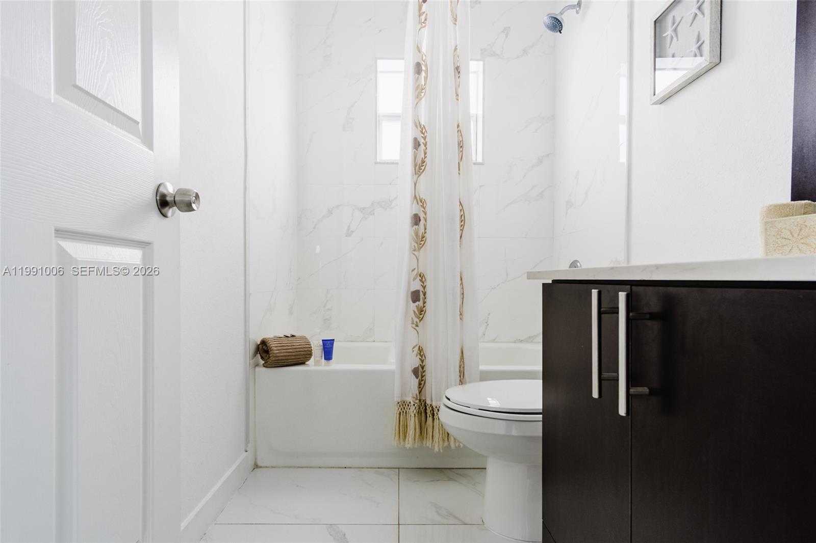 8765 Northwest 22nd Place Miami, FL 33147 - Photo 27 of 37 a bathroom with a sink a toilet and shower