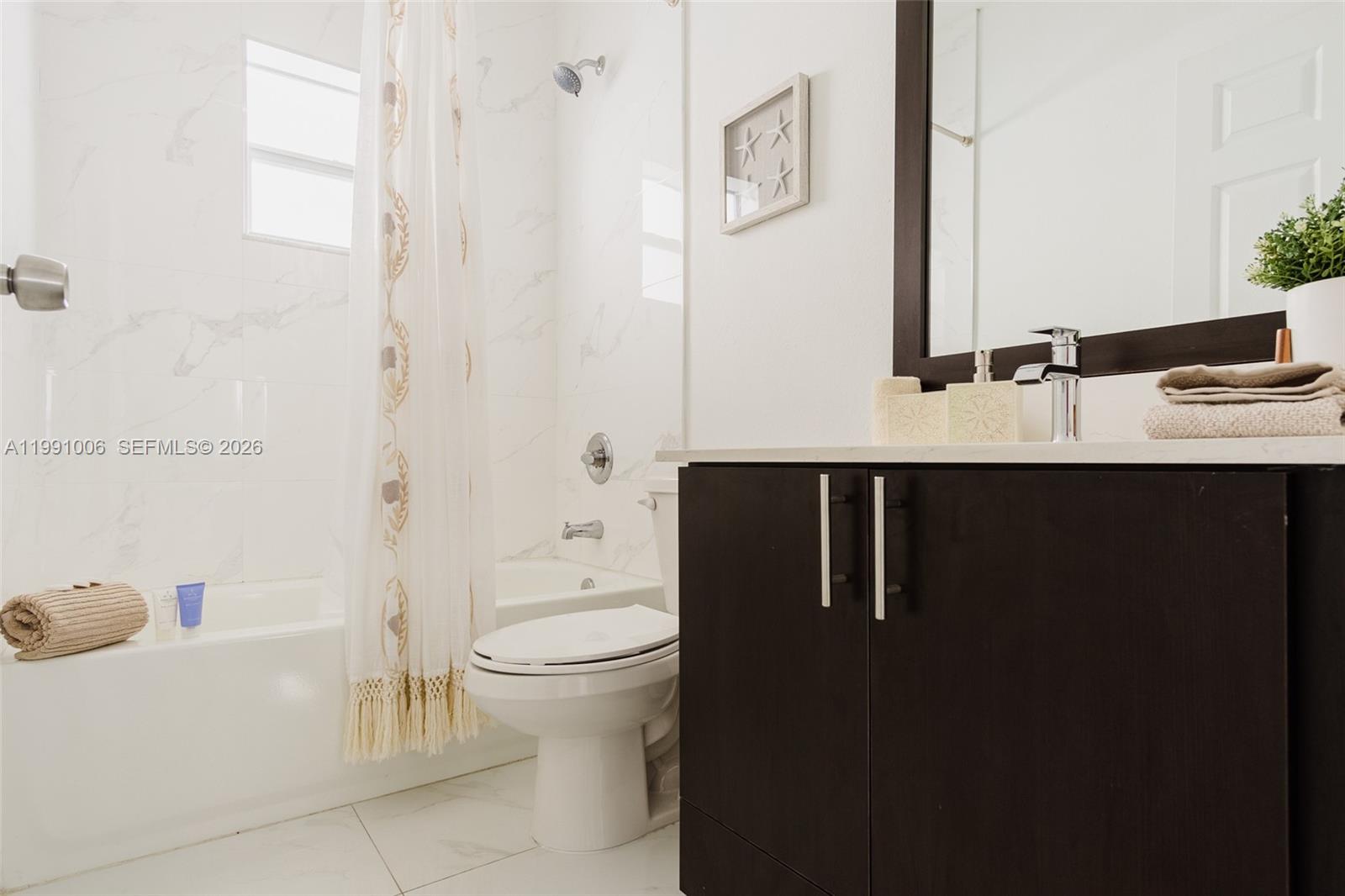 8765 Northwest 22nd Place Miami, FL 33147 - Photo 28 of 37 a bathroom with a sink a toilet and shower