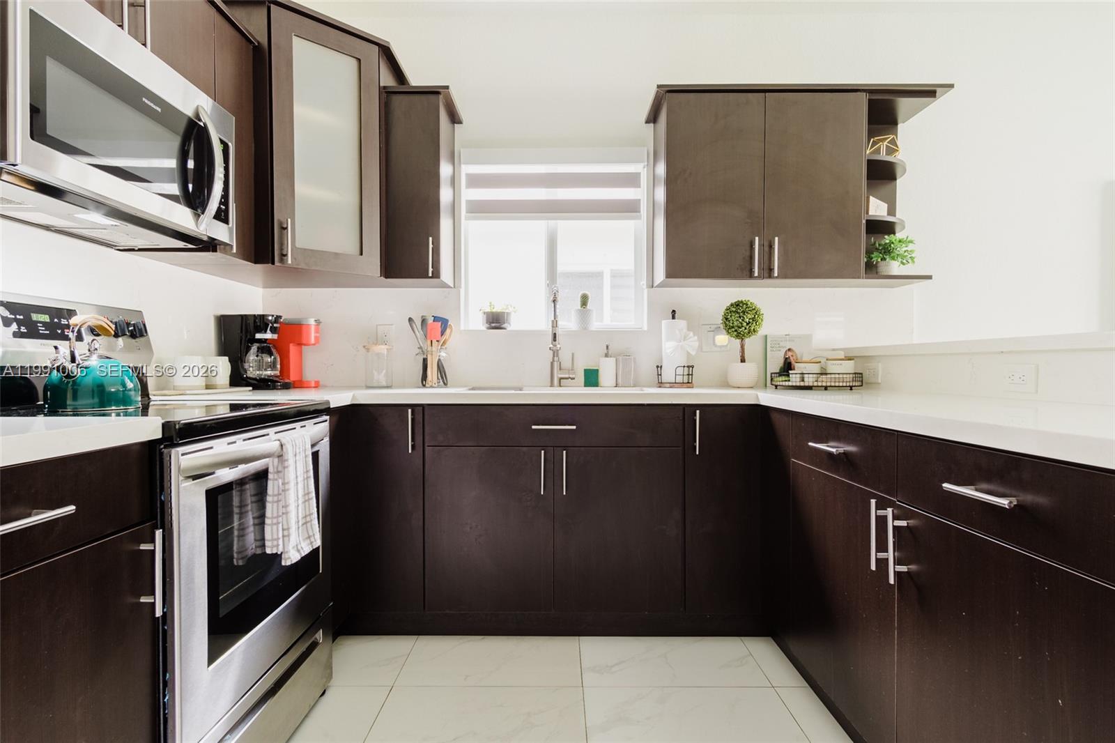 8765 Northwest 22nd Place Miami, FL 33147 - Photo 30 of 37 a kitchen with stainless steel appliances a sink stove and microwave