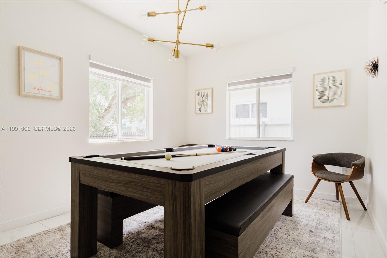 8765 Northwest 22nd Place Miami, FL 33147 - Photo 34 of 37 a room that has a table and a chair in it