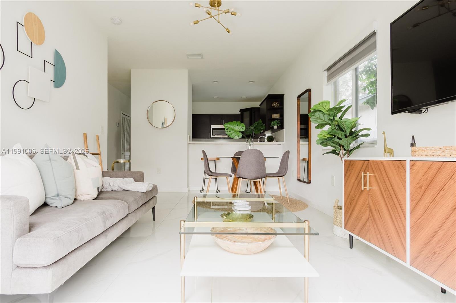 8765 Northwest 22nd Place Miami, FL 33147 - Photo 5 of 37 a living room with furniture and a flat screen tv