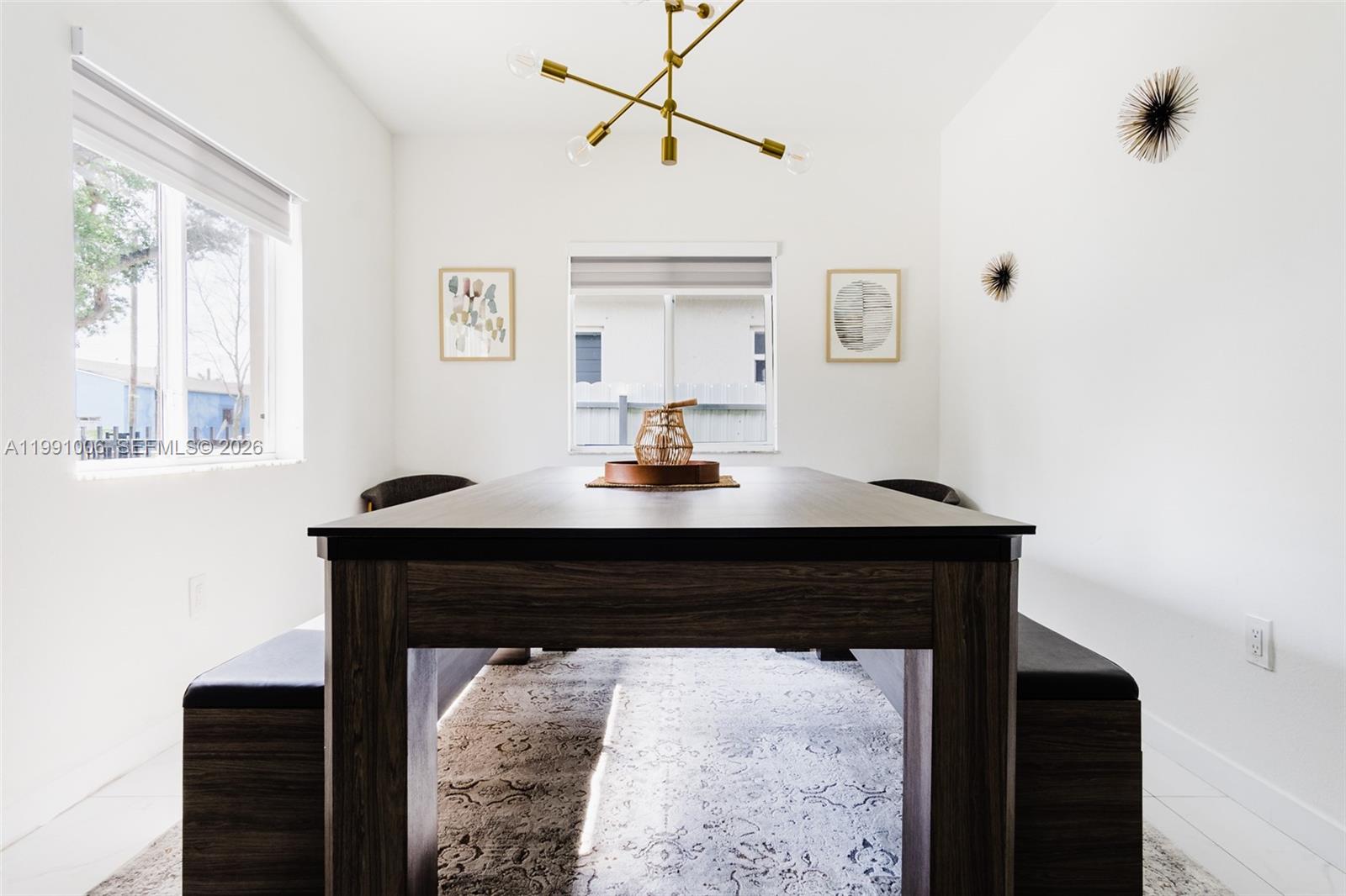 8765 Northwest 22nd Place Miami, FL 33147 - Photo 7 of 37 a living room with a table and windows