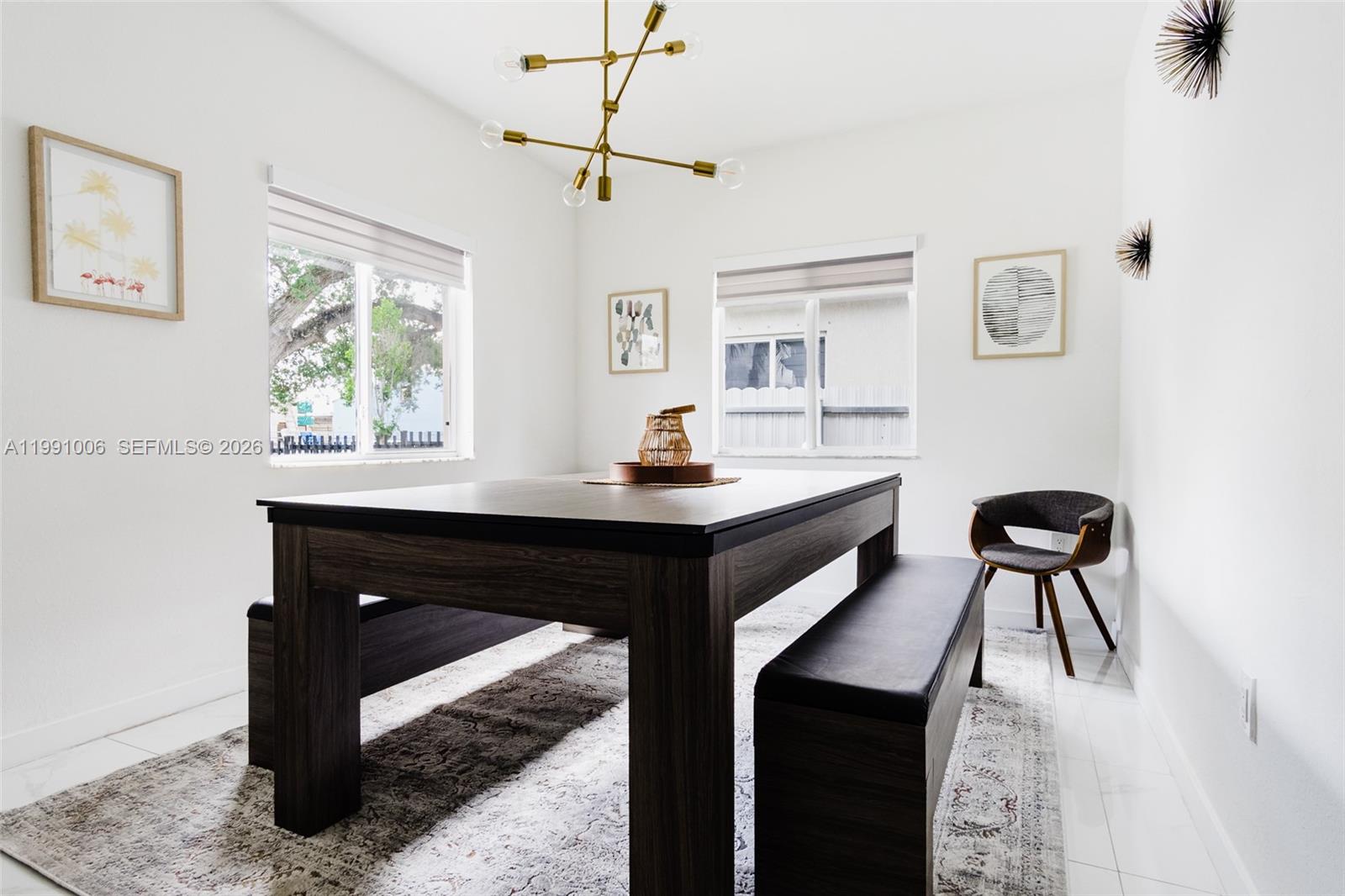 8765 Northwest 22nd Place Miami, FL 33147 - Photo 8 of 37 a dining room with a table and chairs