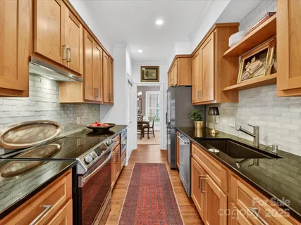 a kitchen with a sink a stove and cabinets