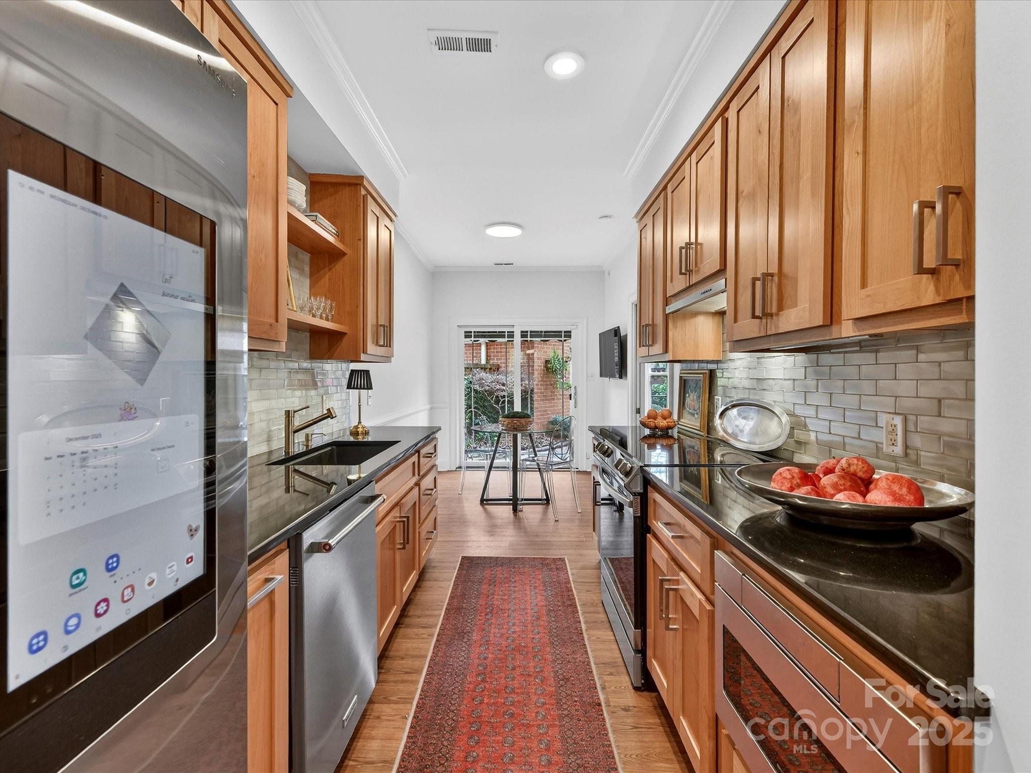 2813 Sharon View Road Charlotte, NC 28210 - Photo 13 of 40 a kitchen with stainless steel appliances granite countertop a stove a sink and a refrigerator