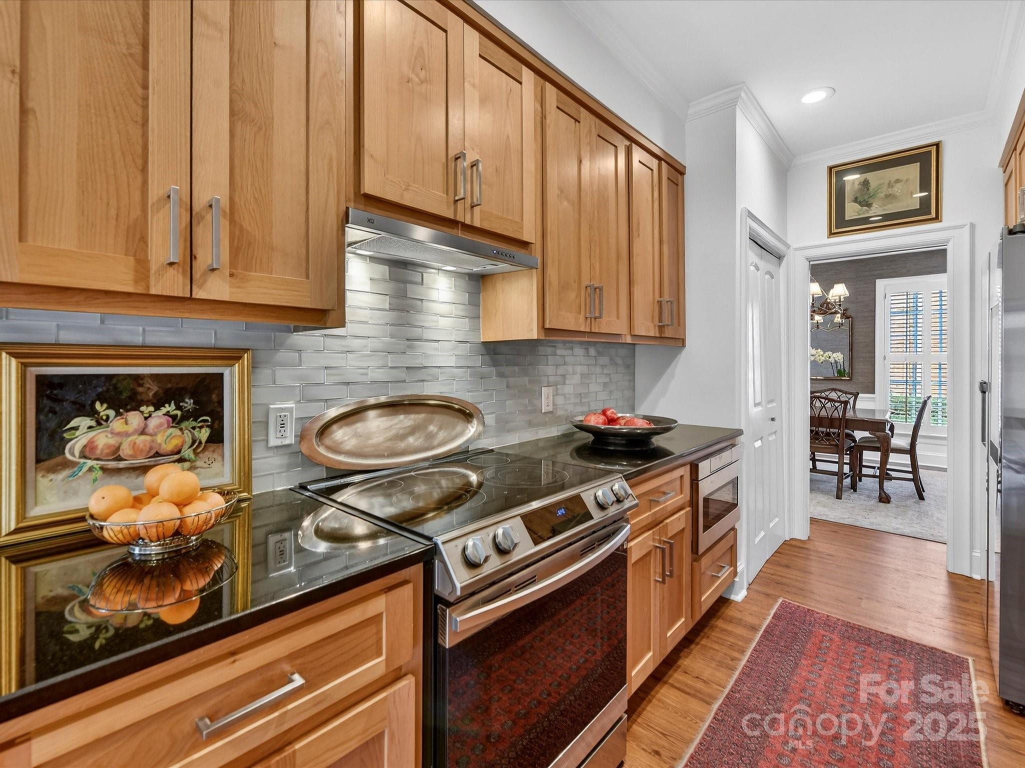 2813 Sharon View Road Charlotte, NC 28210 - Photo 15 of 40 a kitchen with wooden cabinets and a stove top oven