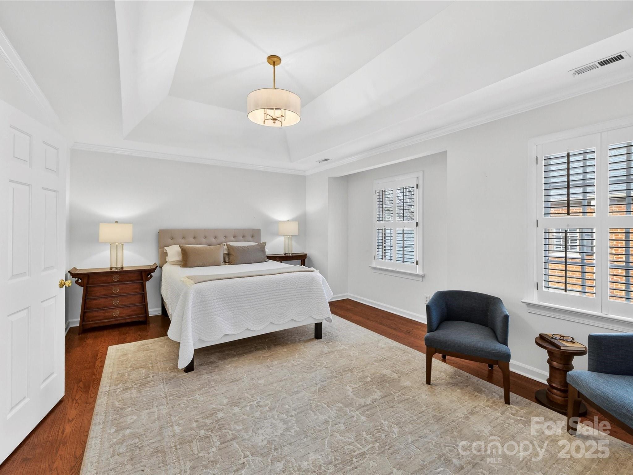 2813 Sharon View Road Charlotte, NC 28210 - Photo 23 of 40 a spacious bedroom with a bed and a chandelier