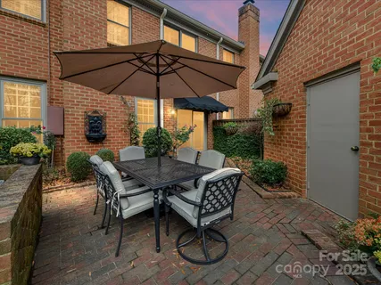 a patio with a patio table and chairs