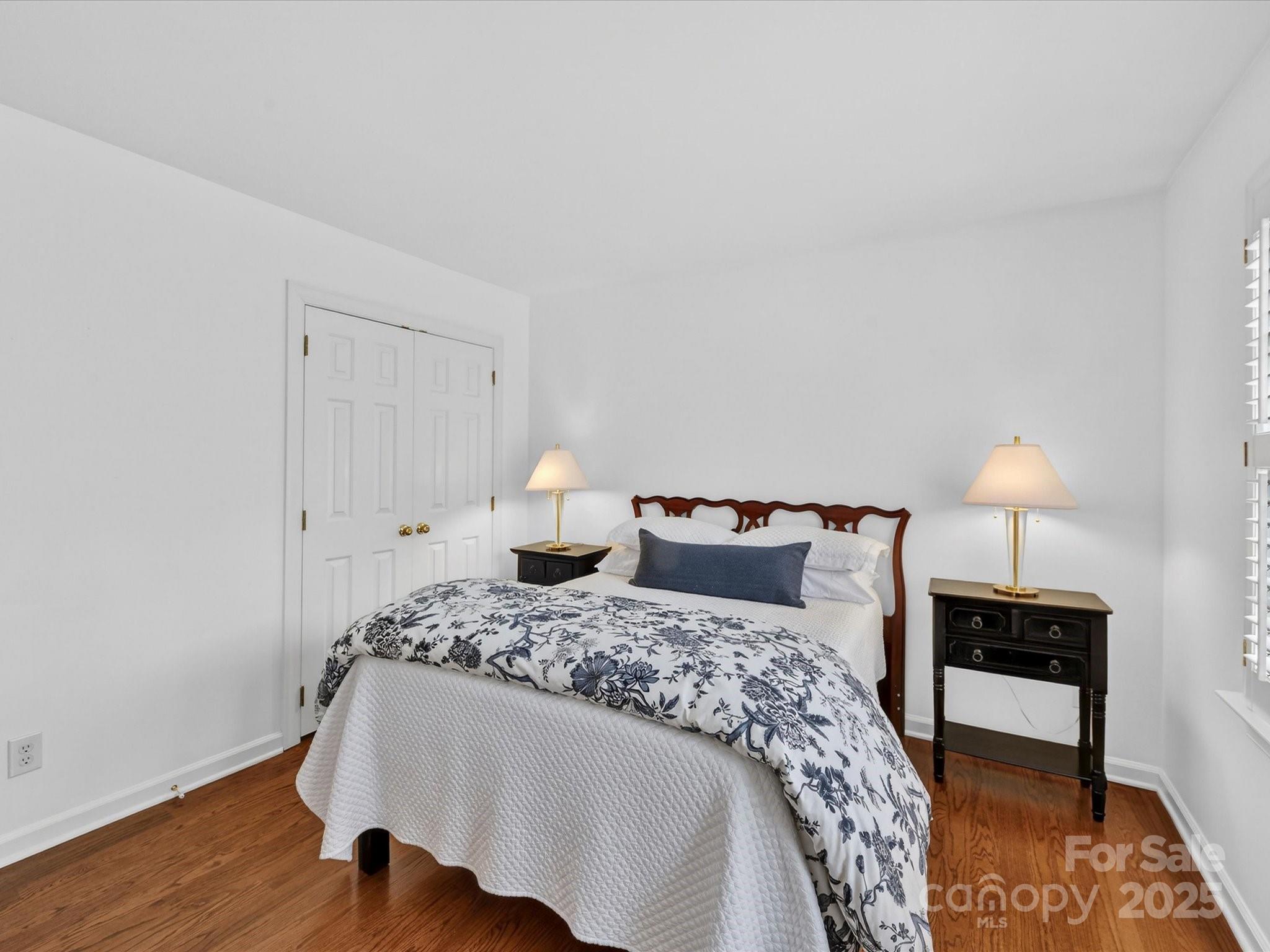 2813 Sharon View Road Charlotte, NC 28210 - Photo 33 of 40 a bedroom with a bed and a lamp