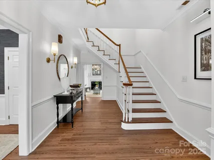 a view of entryway and hall with wooden floor