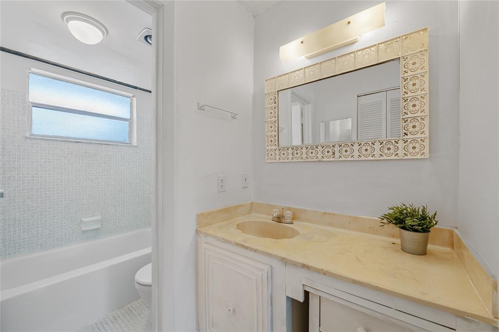 8105 Northwest 61st Street, Unit A206 Tamarac, FL 33321 - Photo 14 of 44 a bathroom with a granite countertop sink a toilet and bathtub