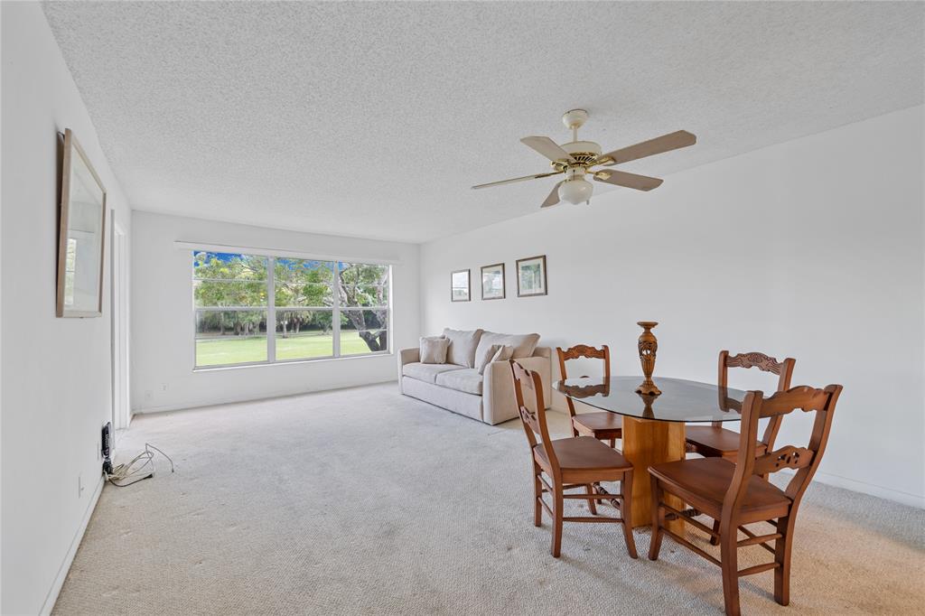 8105 Northwest 61st Street, Unit A206 Tamarac, FL 33321 - Photo 2 of 44 a dining room with furniture and window