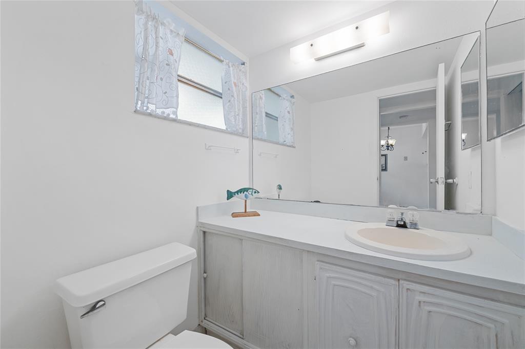 8105 Northwest 61st Street, Unit A206 Tamarac, FL 33321 - Photo 23 of 44 a bathroom with a sink a toilet and mirror