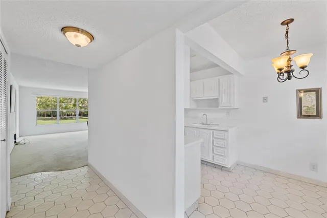 a kitchen with granite countertop a sink a stove and cabinets