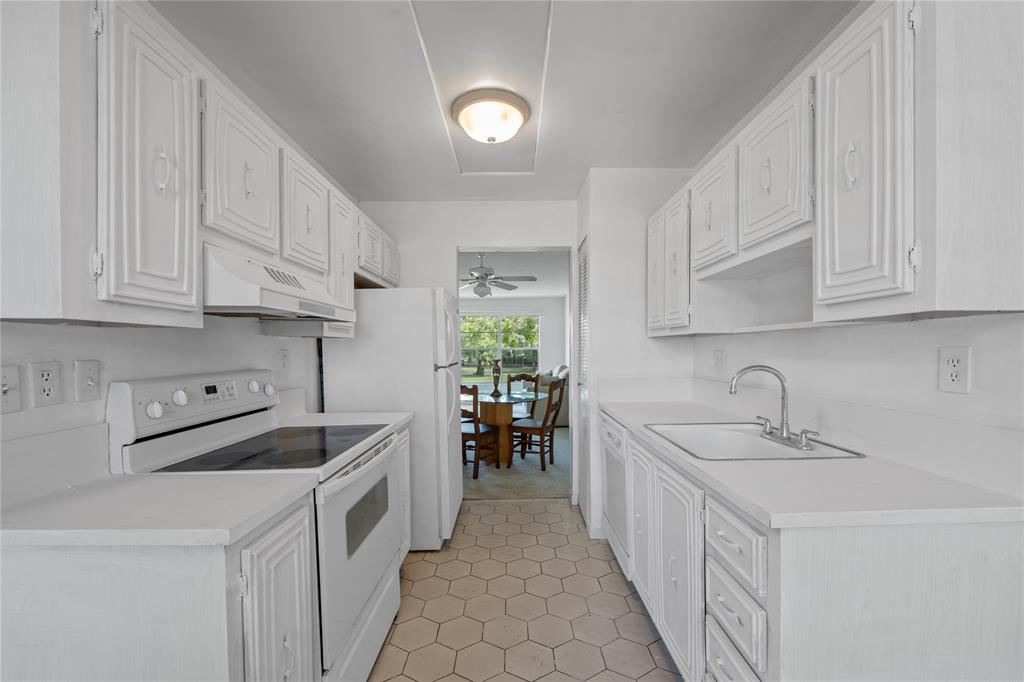 8105 Northwest 61st Street, Unit A206 Tamarac, FL 33321 - Photo 28 of 44 a kitchen with stainless steel appliances granite countertop a sink and cabinets