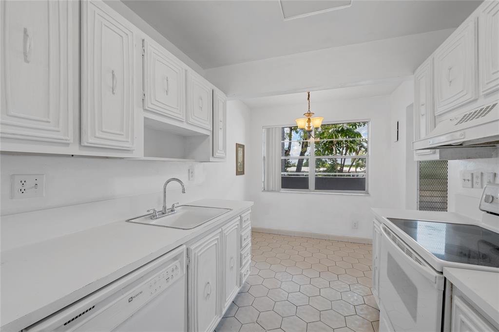 8105 Northwest 61st Street, Unit A206 Tamarac, FL 33321 - Photo 32 of 44 a kitchen with appliances cabinets and a sink
