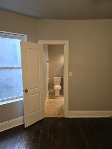 a view of a bathroom with wooden floor