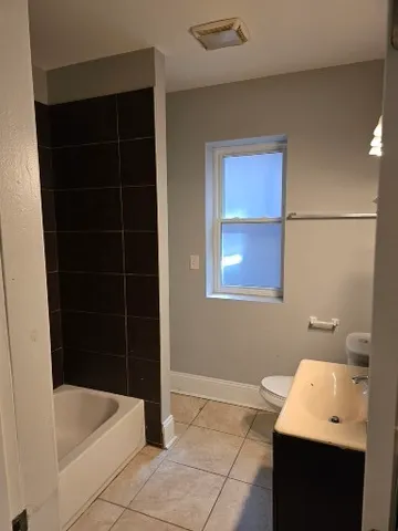 a bathroom with a bathtub and a sink