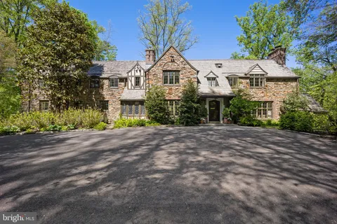 a front view of a house with a yard and a garage