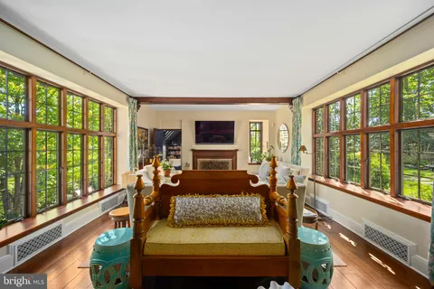 a kitchen with a table chairs and a clock on the wall