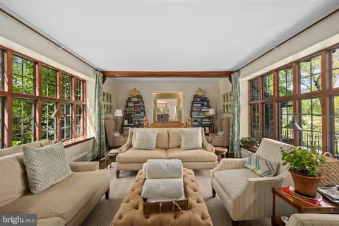 a view of a livingroom with furniture window wooden floor and a ceiling fan
