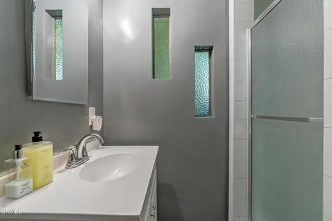 a bathroom with a sink and mirror