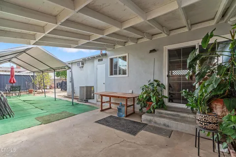 a building outdoor space with patio furniture and garden