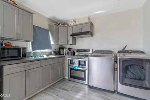 a kitchen with cabinets a sink and appliances