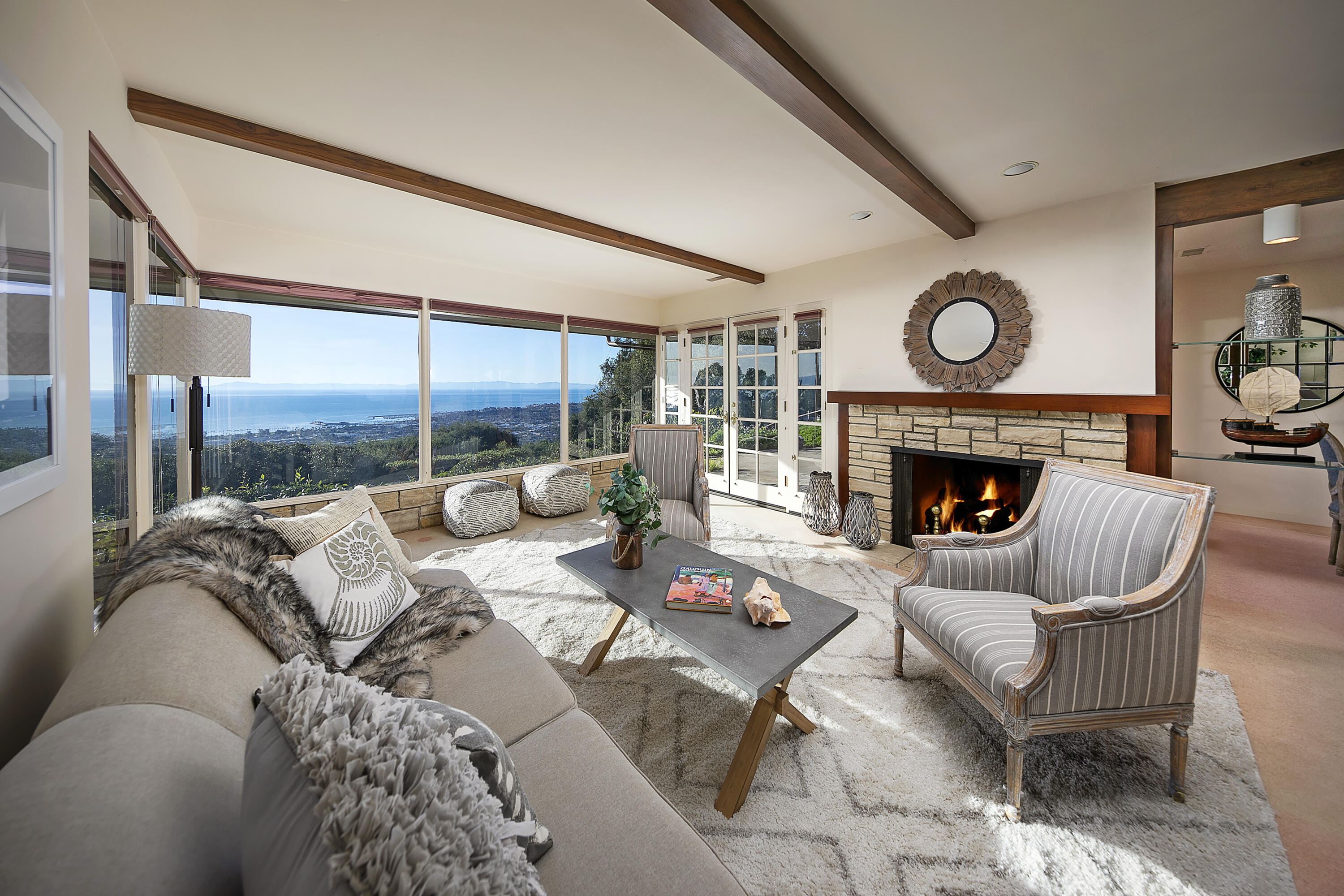 1320 Mission Ridge Road Santa Barbara, CA 93103 - Photo 1 of 27 a living room with furniture a fireplace and a large window