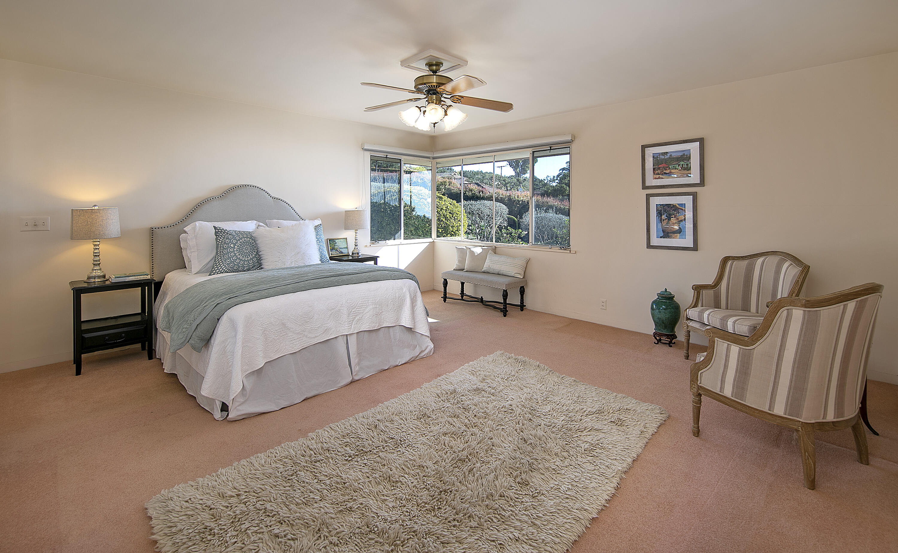 1320 Mission Ridge Road Santa Barbara, CA 93103 - Photo 17 of 27 a spacious bedroom with a bed a chandelier and a window
