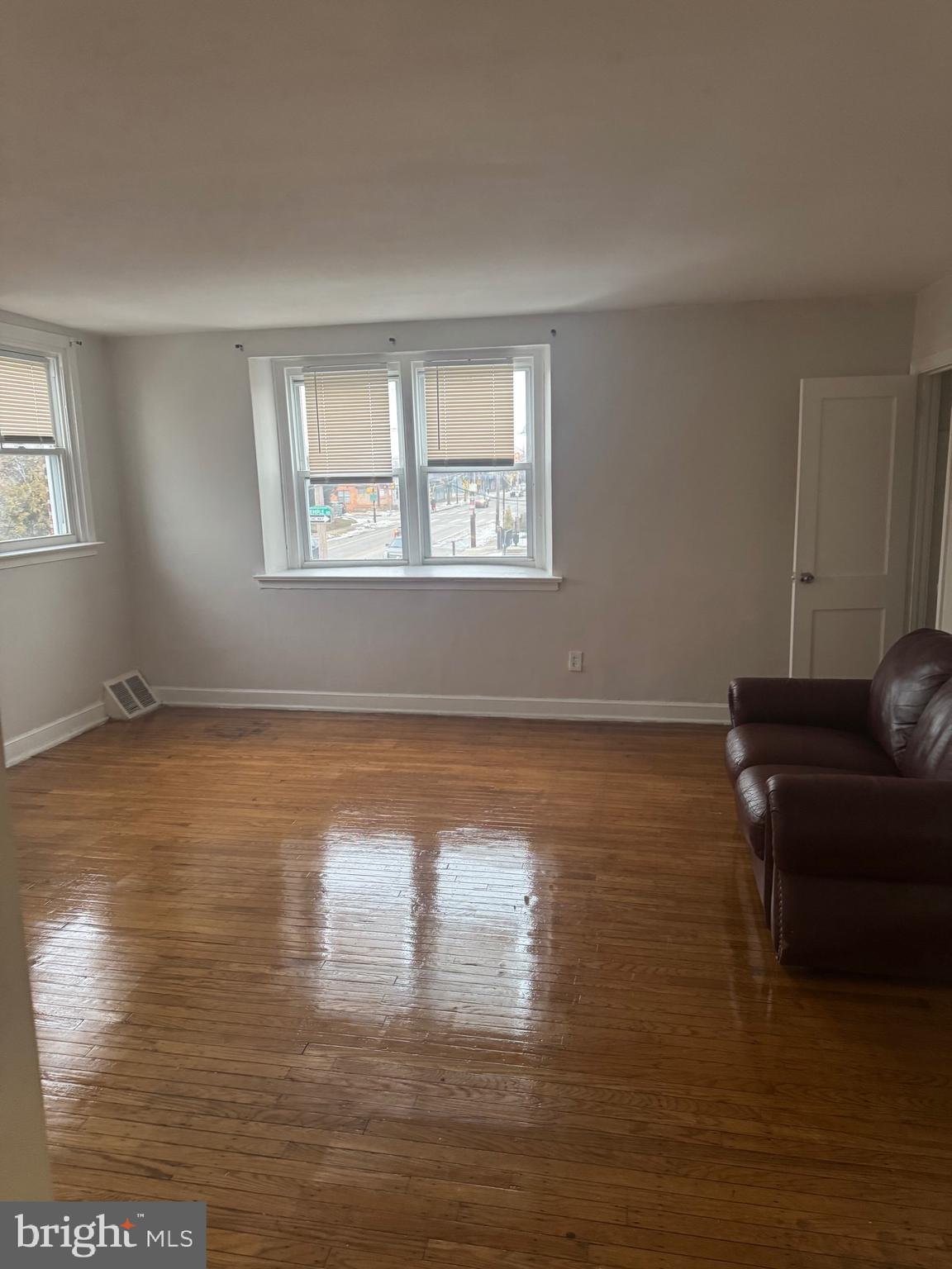 8340 Temple Road Philadelphia, PA 19150 - Photo 2 of 6 a room with wooden floor and a window