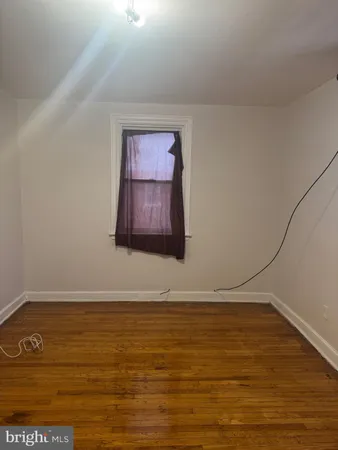 a view of room with wooden floor