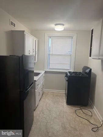 a kitchen with a refrigerator and window