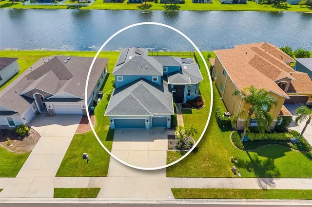 an aerial view of a house with swimming pool and patio