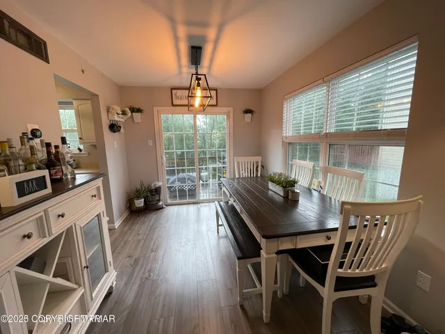 a view of a dining room with furniture window and wooden floor