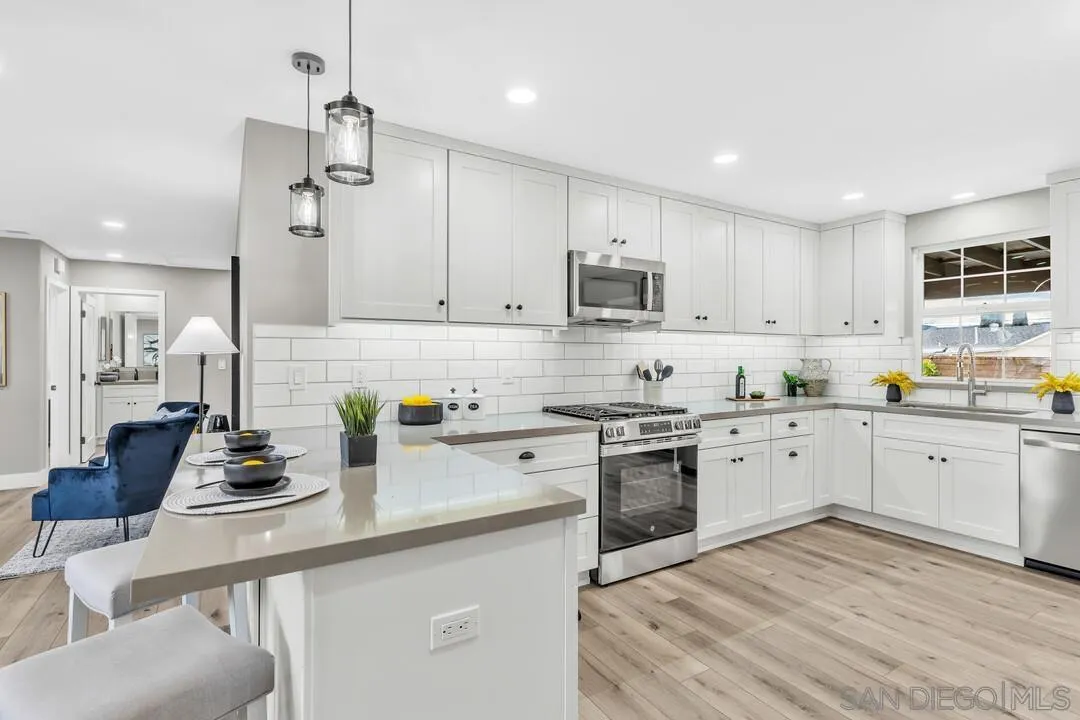9209 Arnaz Way Santee, CA 92071 - Photo 11 of 39 a kitchen with a sink white cabinets and white appliances