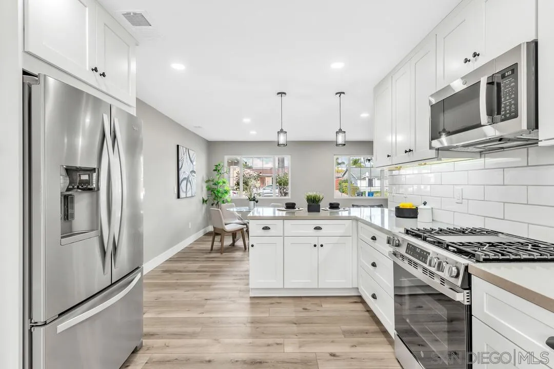 9209 Arnaz Way Santee, CA 92071 - Photo 13 of 39 a kitchen with stainless steel appliances a stove a sink and a refrigerator