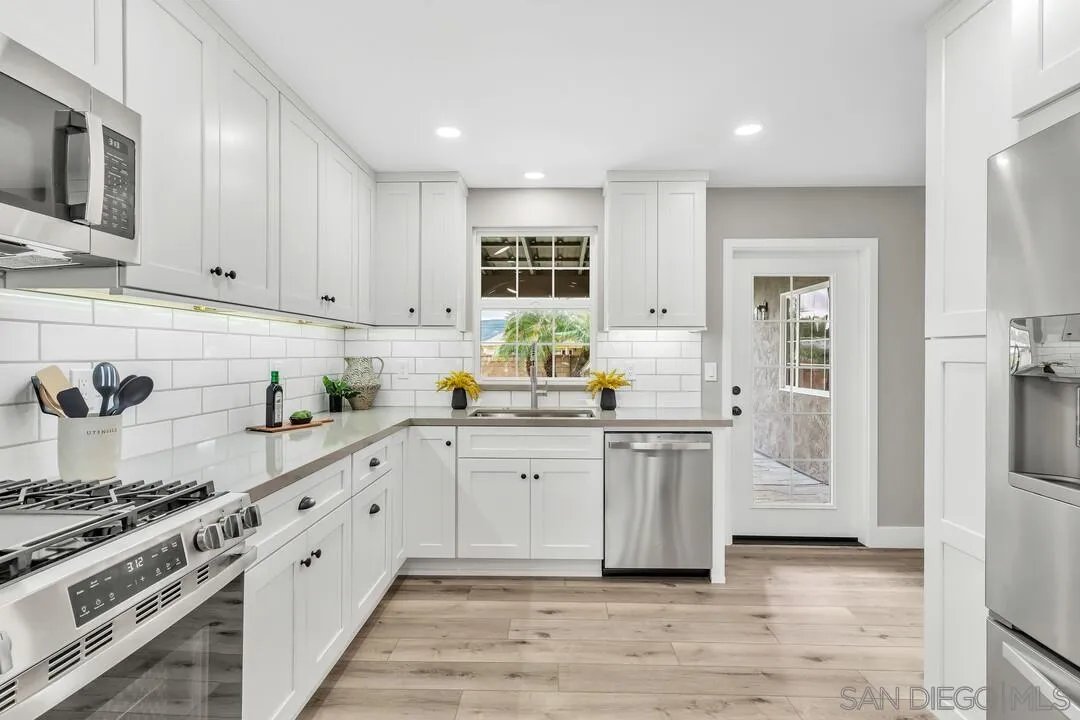 9209 Arnaz Way Santee, CA 92071 - Photo 14 of 39 a kitchen with stainless steel appliances granite countertop a stove and a sink