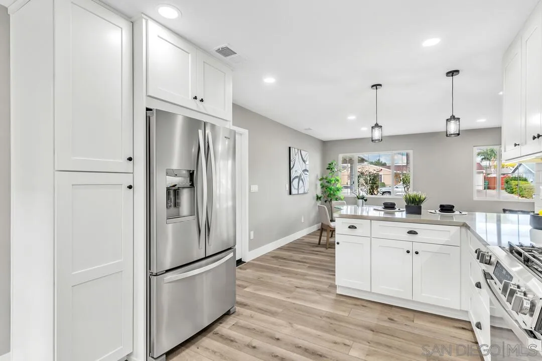 9209 Arnaz Way Santee, CA 92071 - Photo 15 of 39 a kitchen with stainless steel appliances a refrigerator sink and cabinets