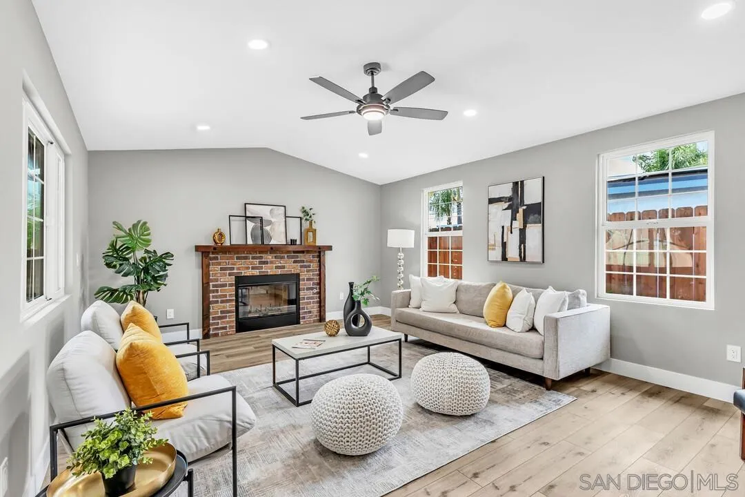 9209 Arnaz Way Santee, CA 92071 - Photo 16 of 39 a living room with furniture a fireplace and a large window