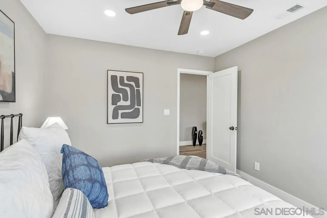 9209 Arnaz Way Santee, CA 92071 - Photo 20 of 39 a bedroom with a large bed and a chandelier