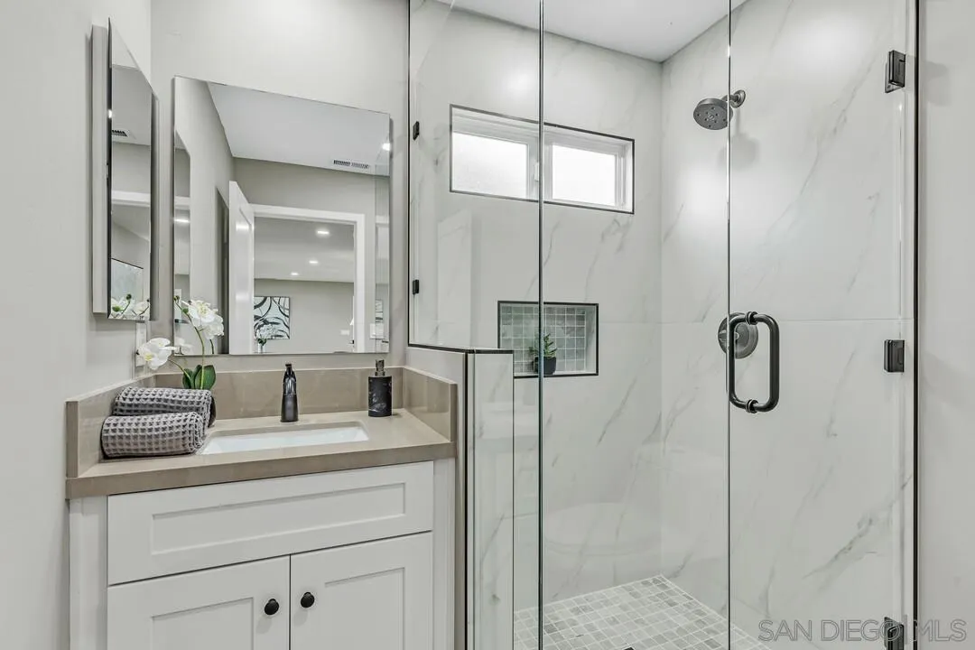 9209 Arnaz Way Santee, CA 92071 - Photo 21 of 39 a bathroom with a granite countertop shower sink vanity and mirror