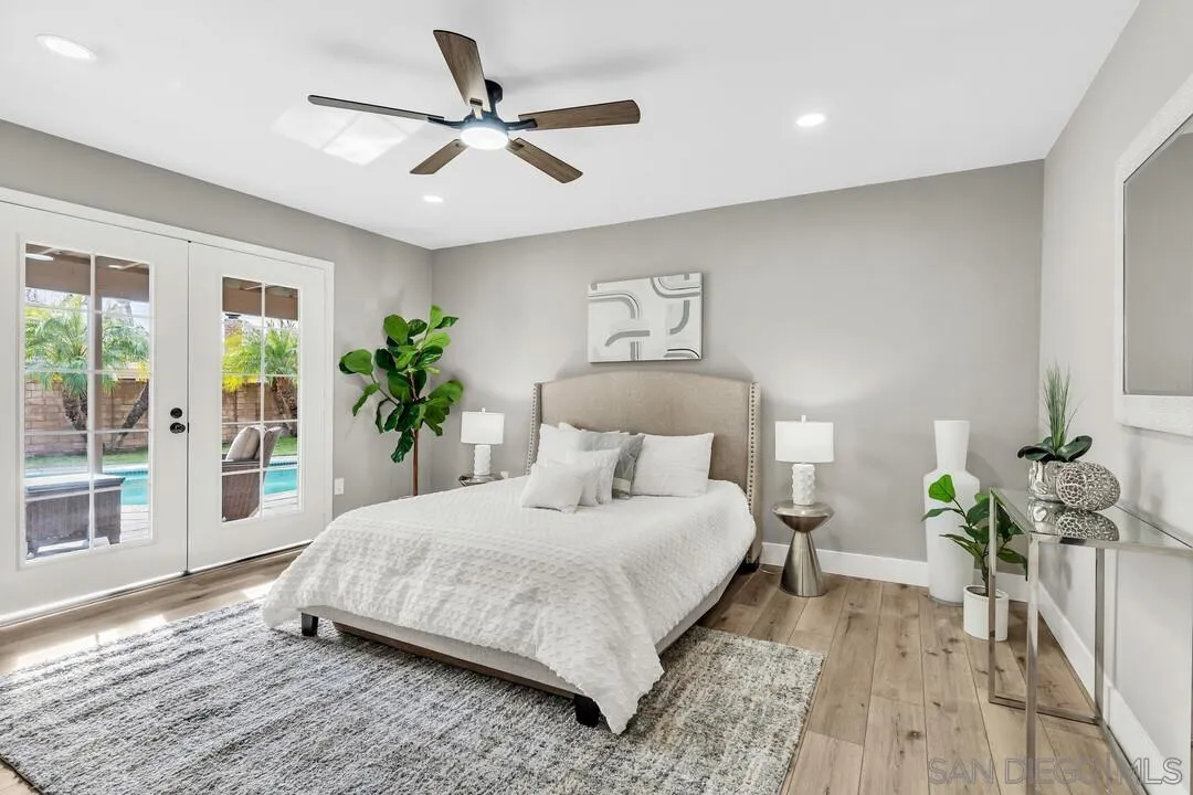 9209 Arnaz Way Santee, CA 92071 - Photo 23 of 39 a bedroom with a large bed and a chandelier