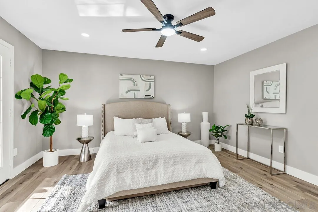 9209 Arnaz Way Santee, CA 92071 - Photo 24 of 39 a bedroom with a bed chandelier and a window