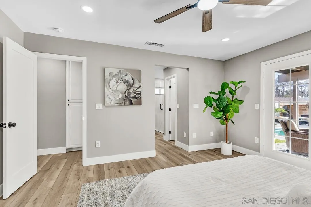9209 Arnaz Way Santee, CA 92071 - Photo 25 of 39 a bedroom with a bed and a potted plant