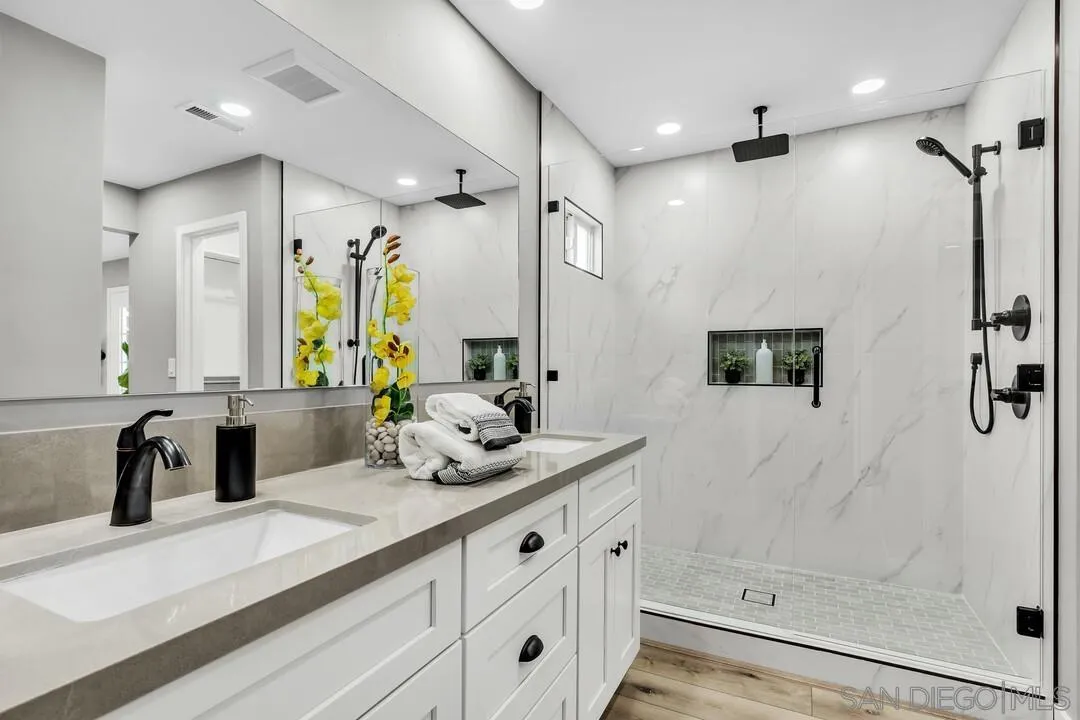 9209 Arnaz Way Santee, CA 92071 - Photo 27 of 39 a bathroom with a double vanity sink mirror and shower